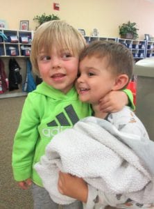 2 toddler boys hugging