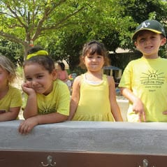 preschool kids in yellow Sunshine House shirts outside