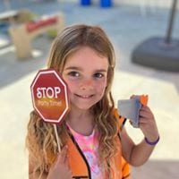 preschool girl holding stop sign police
