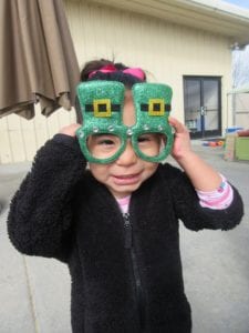 preschool boy with st patricks day glasses photo op