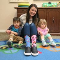 Preschool teacher and kids showing off silly socks during seal week